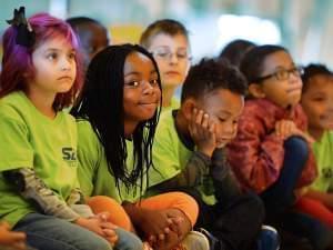 Kids of different colors and ethnicities smiling