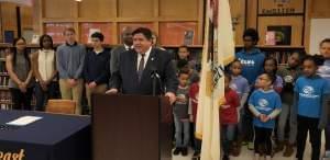 Gov. J.B. Pritzker speaks with reporters before signing legislation at Southeast High School in Springfield, Illinois.