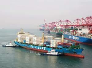 A cargo ship prepares to berth at a port in Qingdao in China's eastern Shandong province on Wednesday. New tariffs went into effect Friday.