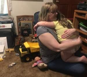 Anne Polston holds her 2-year-old granddaughter.