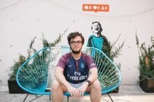 A young man sits outside Hola Code offices in Mexico City