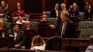 House Speaker Michael Madigan speaking to colleagues and Governor J.B. Pritzker