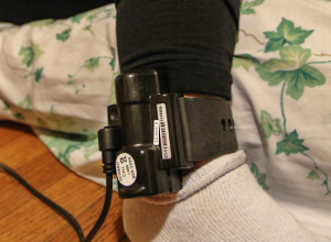 This is an electronic monitoring device. A radio frequency electronic monitor tracks whether or not someone is in a specific location, while a GPS device monitors their location. 