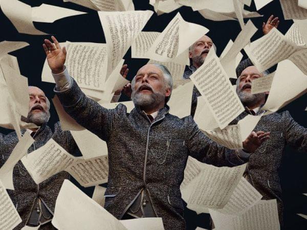 man with papers flying around him