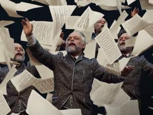 man with papers flying around him