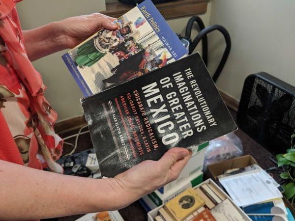 Two books in a womans hands.