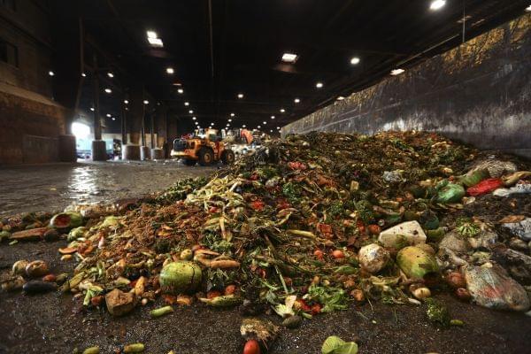 In this Aug. 29, 2018, photo, at the Waste Management facility in North Brooklyn, tons of leftover food sits piled up before being processed into "bio-slurry," in New York.