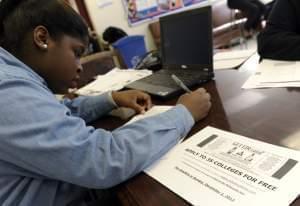 A student fills out a college enrollment application at Roosevelt High School in Washington.