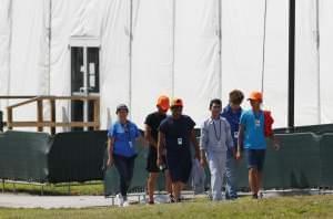 Migrant children walk outside the Homestead Temporary Shelter for Unaccompanied Children in May in Homestead, Fla.