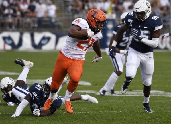 Illinois running back Ra'Von Bonner breaks free of Connecticut linebacker D.J. Morgan and runs in for a touchdown during the first half of an NCAA college football game, Saturday, Sept. 7, 2019, in East Hartford, Conn.