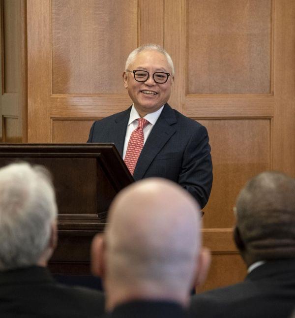 Sidney Lu stands behind a podium in the Engineering Hall 