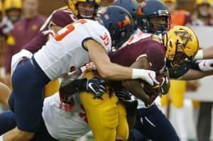 Illinois linebacker Jake Hansen (35) stops Minnesota running back Rodney Smith (1) on a run in the first quarter of an NCAA college football game Saturday, Oct. 5, 2019, in Minneapolis.