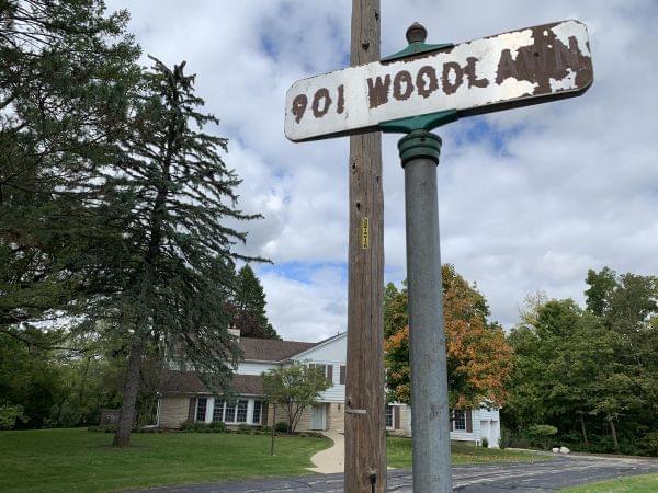 The rusting street sign in front of the Northern Illinois University president's residence.