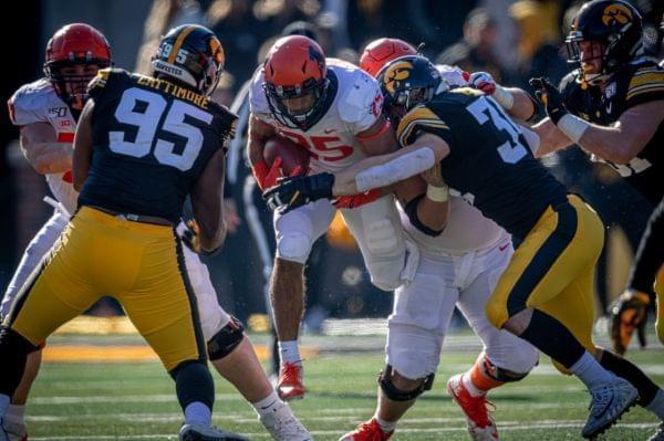 Illinois running back Dre Brown tries to run through the Iowa defense at Kinnick Stadium on Saturday.