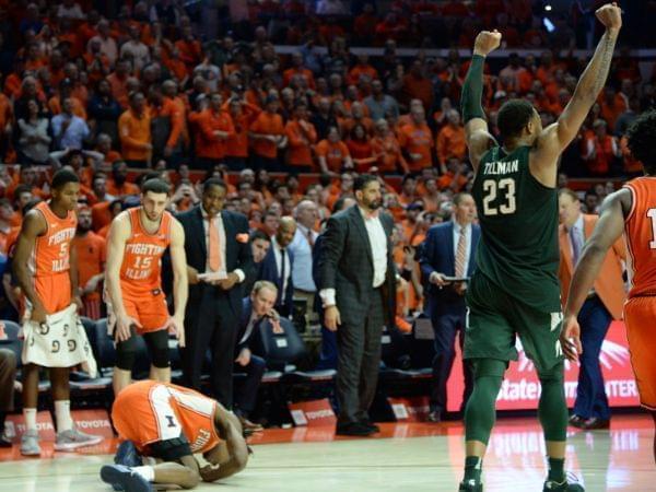 Michigan State's Xavier Tillman celebrates while Illinois' Ayo Dosunmu writhes in pain.