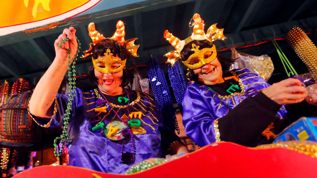 Float riders toss trinkets at the Krewe of Cleopatra Mardi Gras parade in New Orleans, Friday, Feb. 2, 2018. Mardi Gras season is kicking into high gear with a slew of major parades throughout New Orleans. Although Carnival season officially began Jan. 6, the festivities really kick into high gear the two weekends ahead of Fat Tuesday.