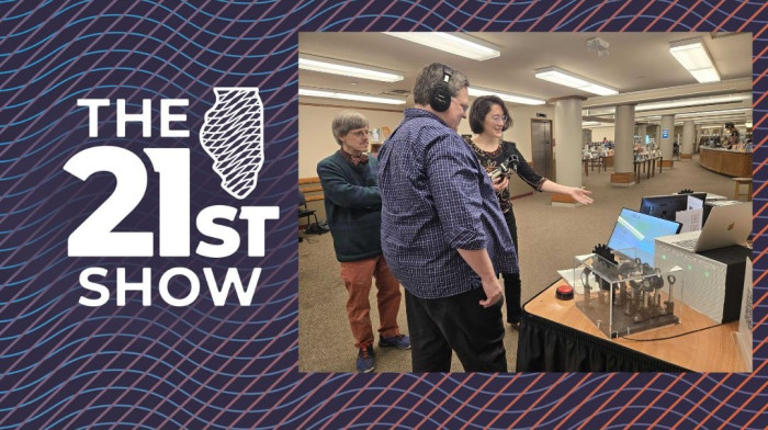 University of Illinois Physics professors Gina Lorenz and Paul Kwiat describe a Quantum Network display to Brian Mackey, host of The 21st Show, at the Urbana Free Library.