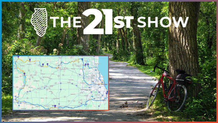 next to a paved bike path, a red bicycle leans against a tree in a lush forest