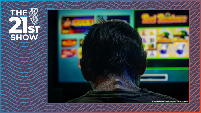 a man with short hair is silhouetted against the glow of video gambling machines