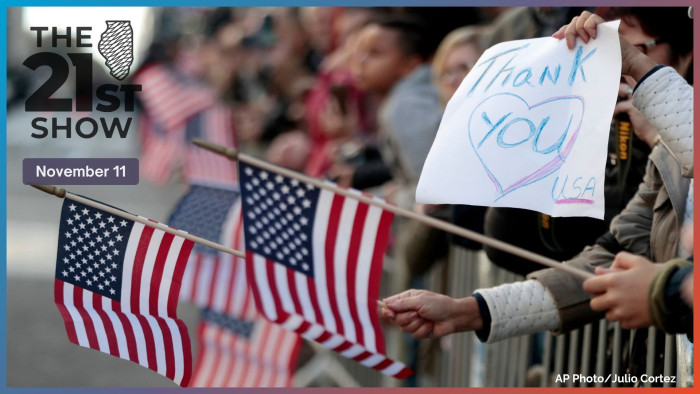People wave U.S. flags during the Veterans Day parade, Friday, Nov. 11, 2016, in New York. 