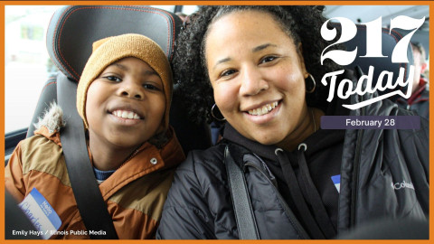 A son amd mother smile together in bus seats.