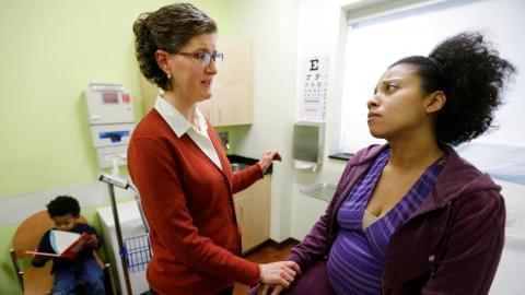 Certified nurse midwife Danielle Kraessig meets with patient Yakini Branch at the PCC South Family Health Center Wednesday, Jan. 23, 2013, in Berwyn, Ill. The clinic may receive a permit to operate the first birth center in Illinois as soon as Feb. 5, 2013. Midwives and other supporters of birth alternatives for Illinois women with low-risk pregnancies have been working for years to provide such centers, which are already available in 37 other states.