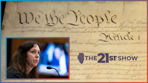 the US constitution is written on dark brown paper in elaborate script; the inset photo features a white woman with brown hair and wearing a black top; she's looking to her right and her lips are pursed; on a TV monitor in the background — out of focus — you can see a senator holding up a piece of paper, presumably asking a question or making a point during Shogan's confirmation hearing