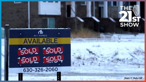 An advertising sign for building land stands in front of a new home construction site in Northbrook, Illinois in this file photo from December 2021.