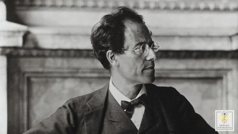 A black and white picture of Gustav Mahler wearing a suit and glasses.