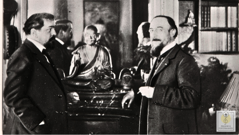 Erik Satie in a parlor room with Claude Debussy