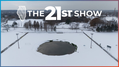 an aerial photo shows a group of soccer fields covered in snow, with a giant gaping hole in the middle