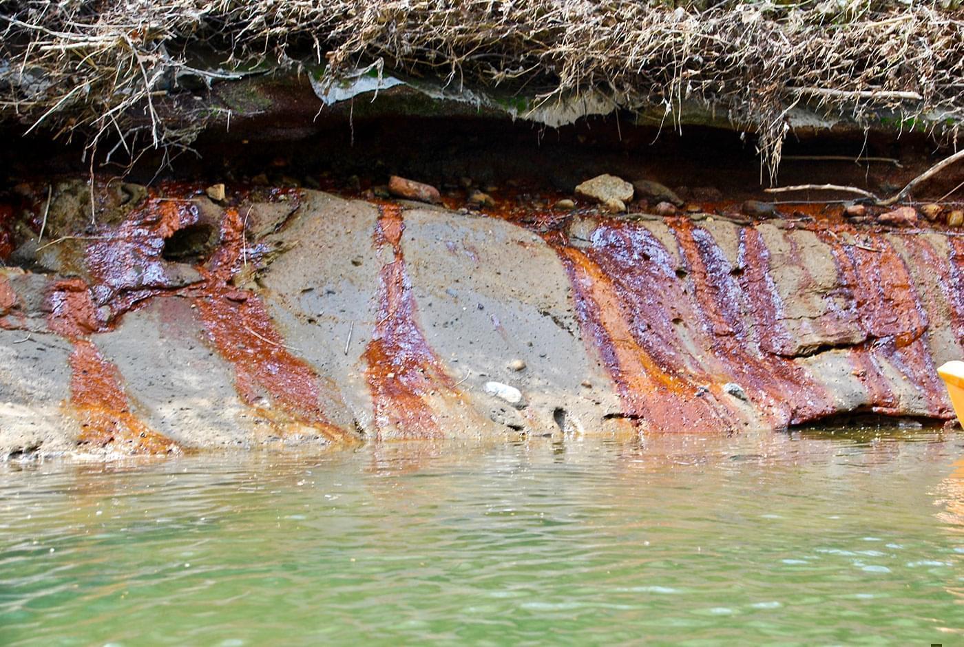 discolored water entering the Middle Fork river through seeps on the riverbank